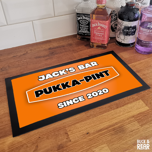 Personalised Pukka Pint bar mat on a counter top